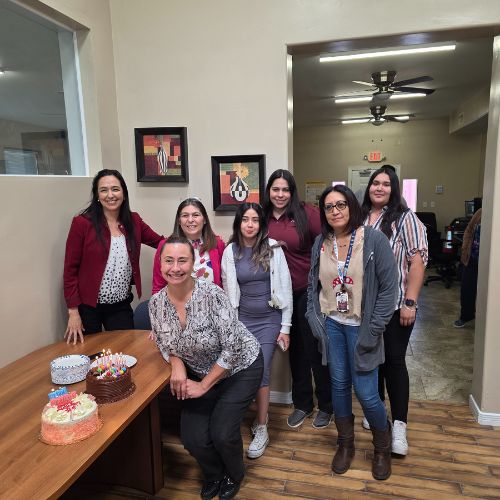 A group photo of the ACG team with birthday decorations and a happy birthday banner.