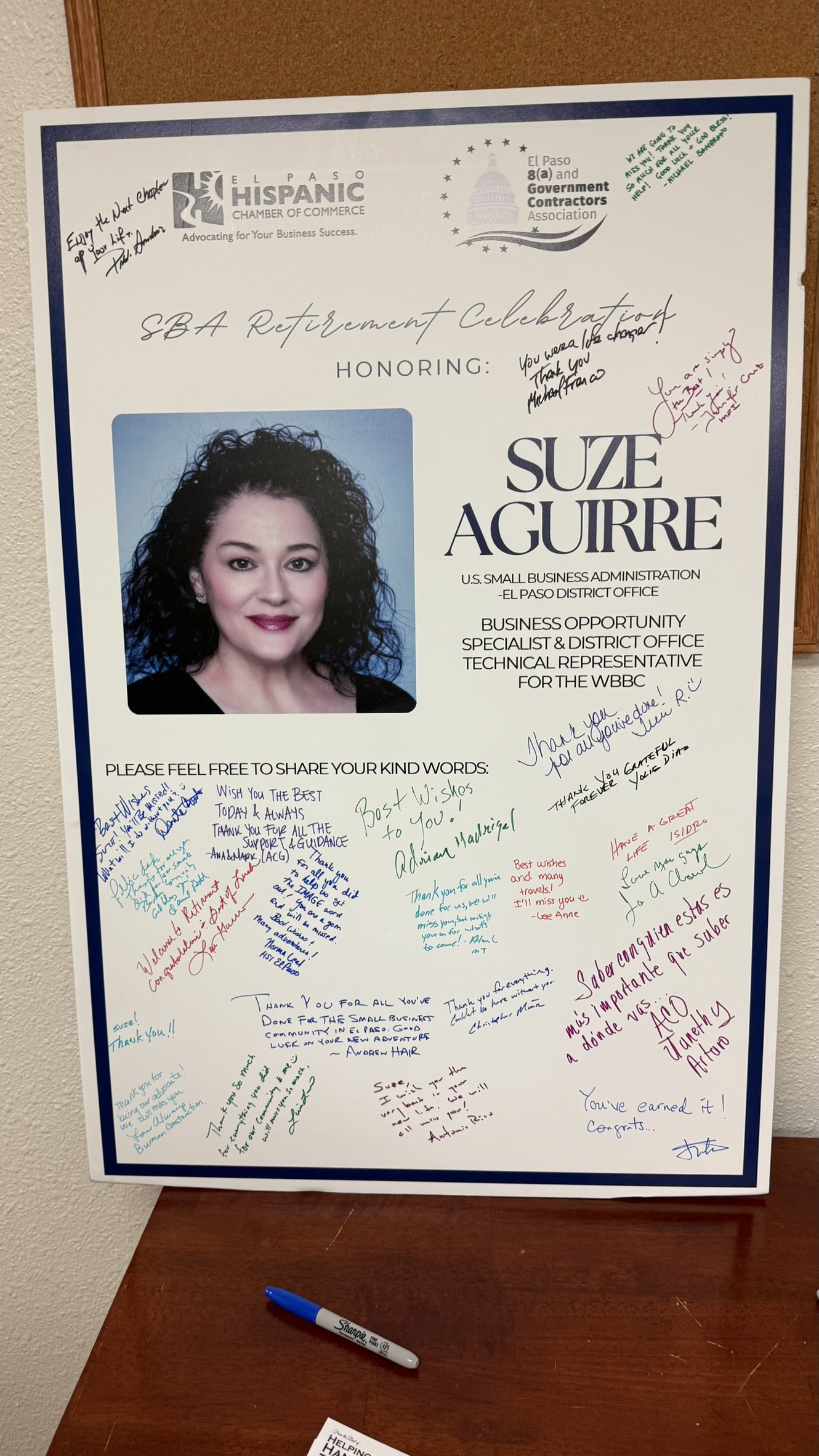 Close-up of the postcard message sent by Suze Aguirre to ACG, placed beside a coffee mug and notebook.