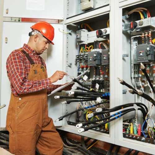 Fiber optic technician documenting installation with testing equipment in a federal data room.