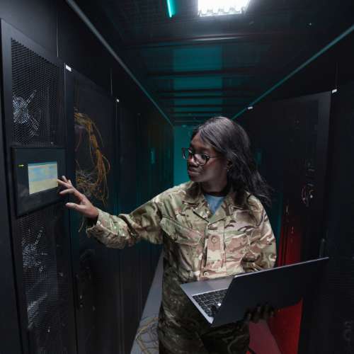 Fiber optic cable installation being performed in a secure federal IT environment.
